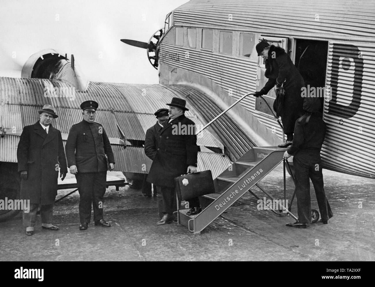 A Junkers Ju52 is received by customs officials after landing at Berlin Tempelhof Airport. Stock Photo