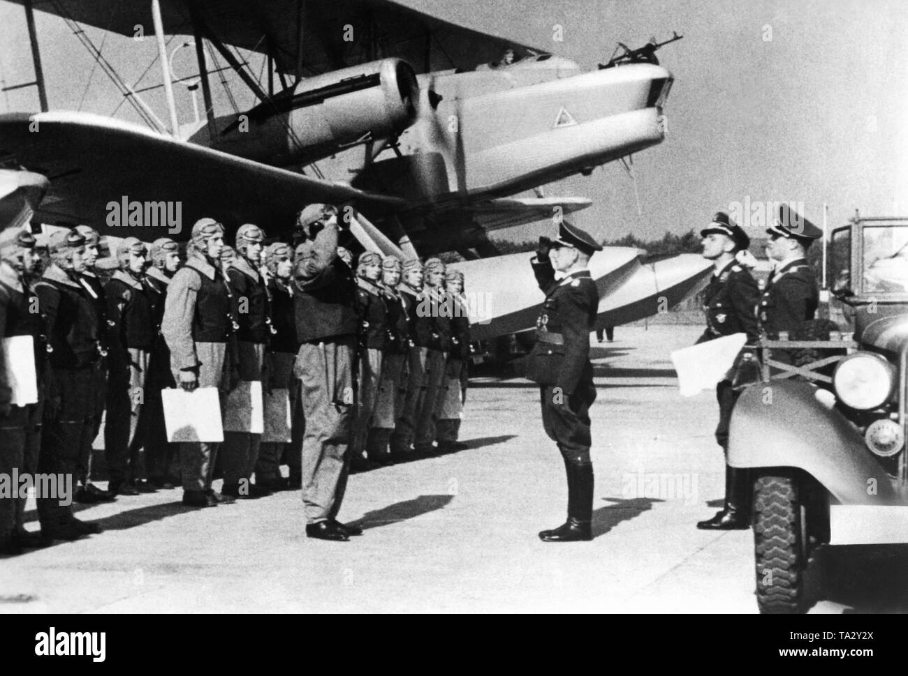 The squadron commander reports the lined up crew to the commander. It is a filmstill from the propaganda film 'Flieger zur See' from 1938/1939. Stock Photo