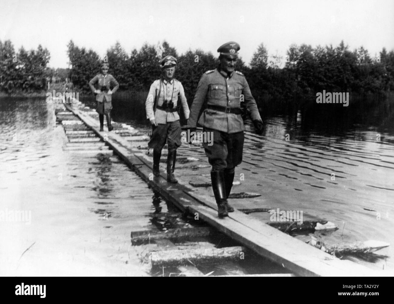 Makeshift wooden bridge over water Stock Photo - Alamy