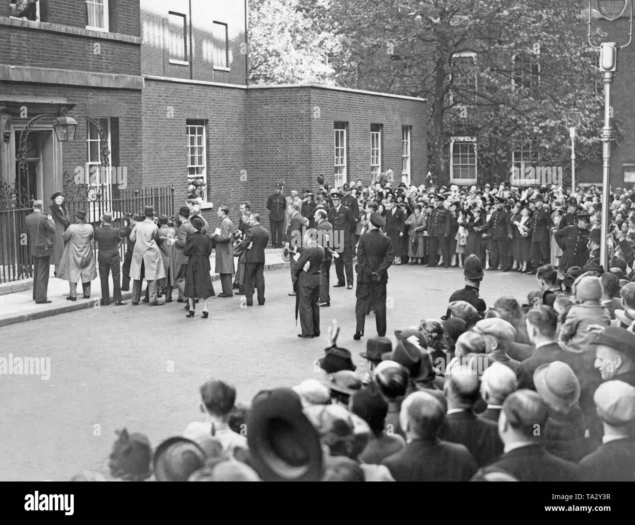 The wife of British Prime Minister, Anne Chamberlain, in front of the residence of the Prime Minister at 10 Downing Street. She leaves the house for a walk and is greeted by a crowd. Stock Photo