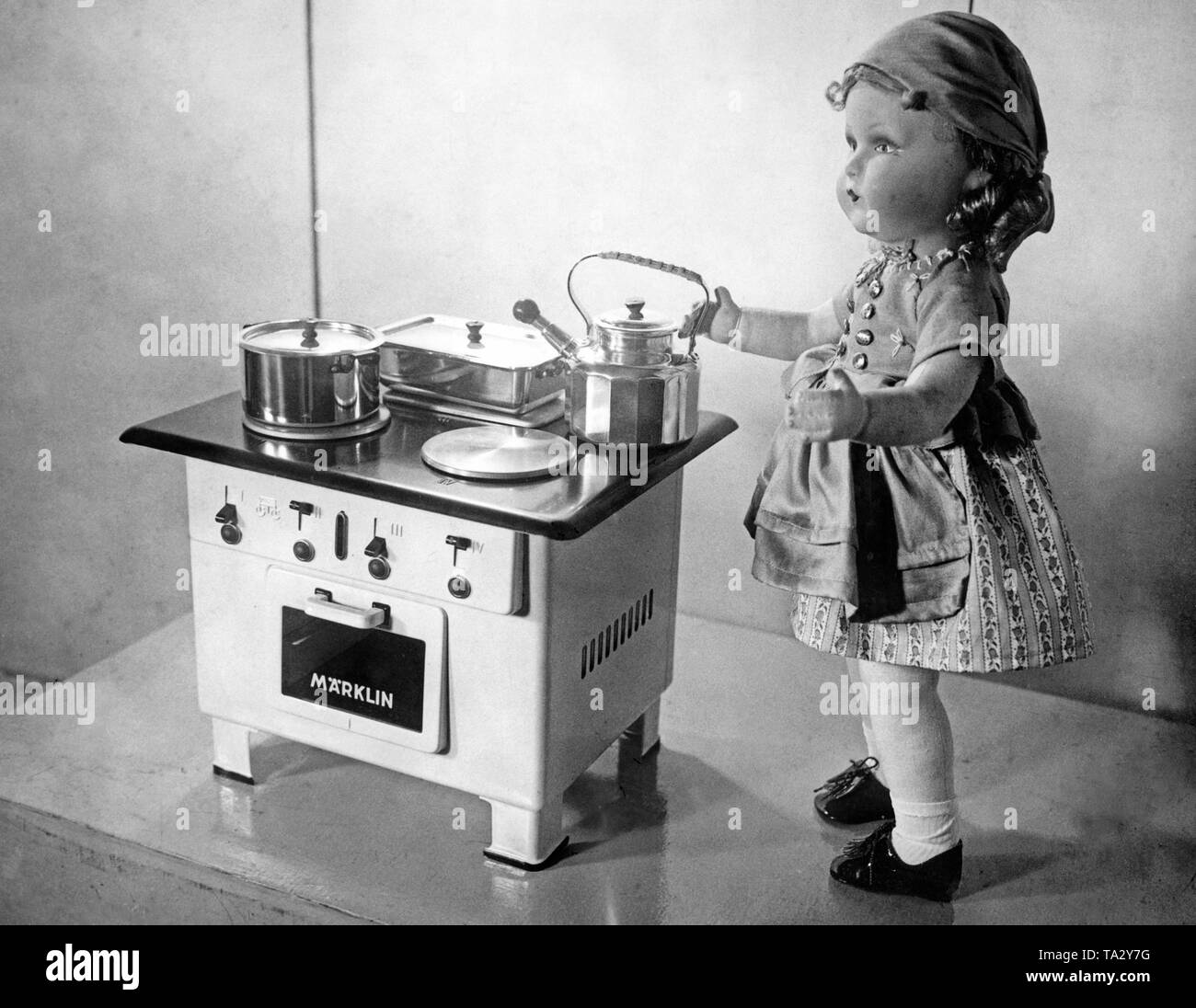 A doll at the stove Stock Photo Alamy