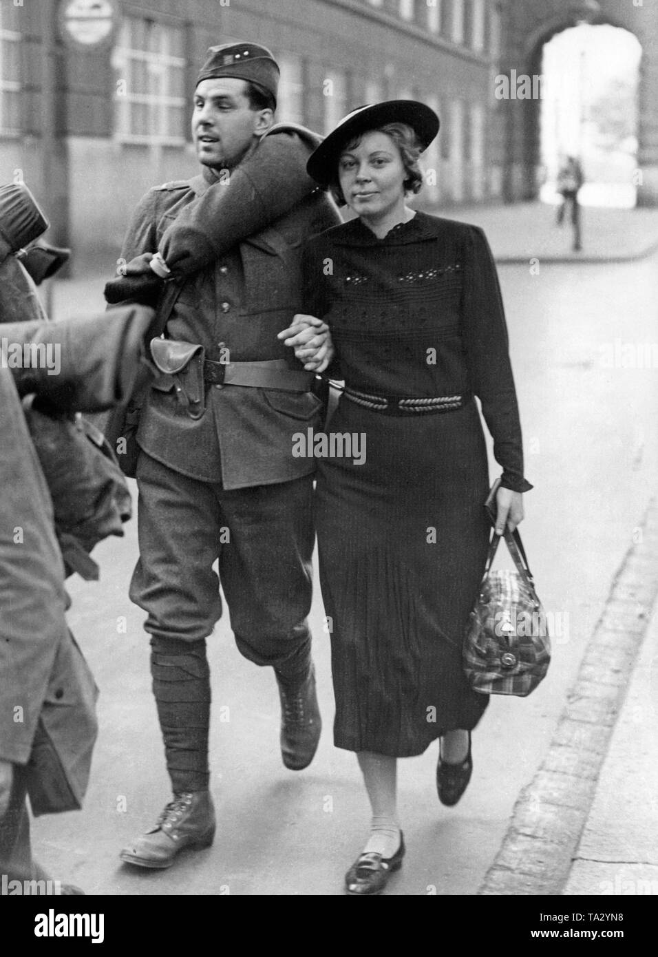 A Czech soldier walks with his girlfriend to the Dennis railway station in Prague. Four days before the expiration of Hitler's ultimatum, the Czechoslovak Army finished its mobilization. Stock Photo