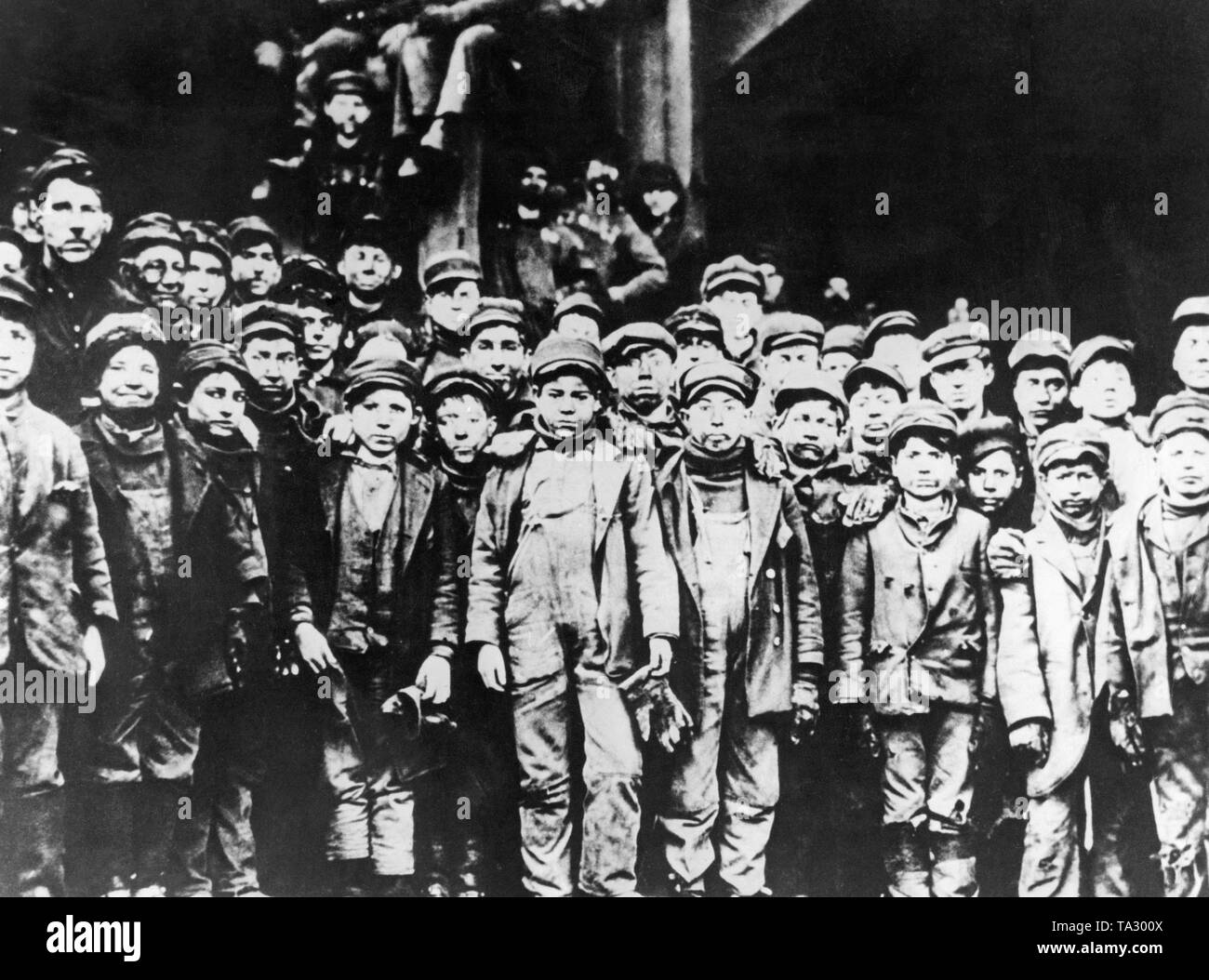 Child laborers in front of a coal mine in S. Pittstin, Pennsylvania. The photo was taken by photographer Lewis Wicker Hine on behalf of the National Child Labor Committee. Lewis Heine devoted his work to child labor in the USA and Europe. Between 1908 and 1921 about 5,000 photos were taken. Lewis considered himself as a social documentary photographer. Stock Photo