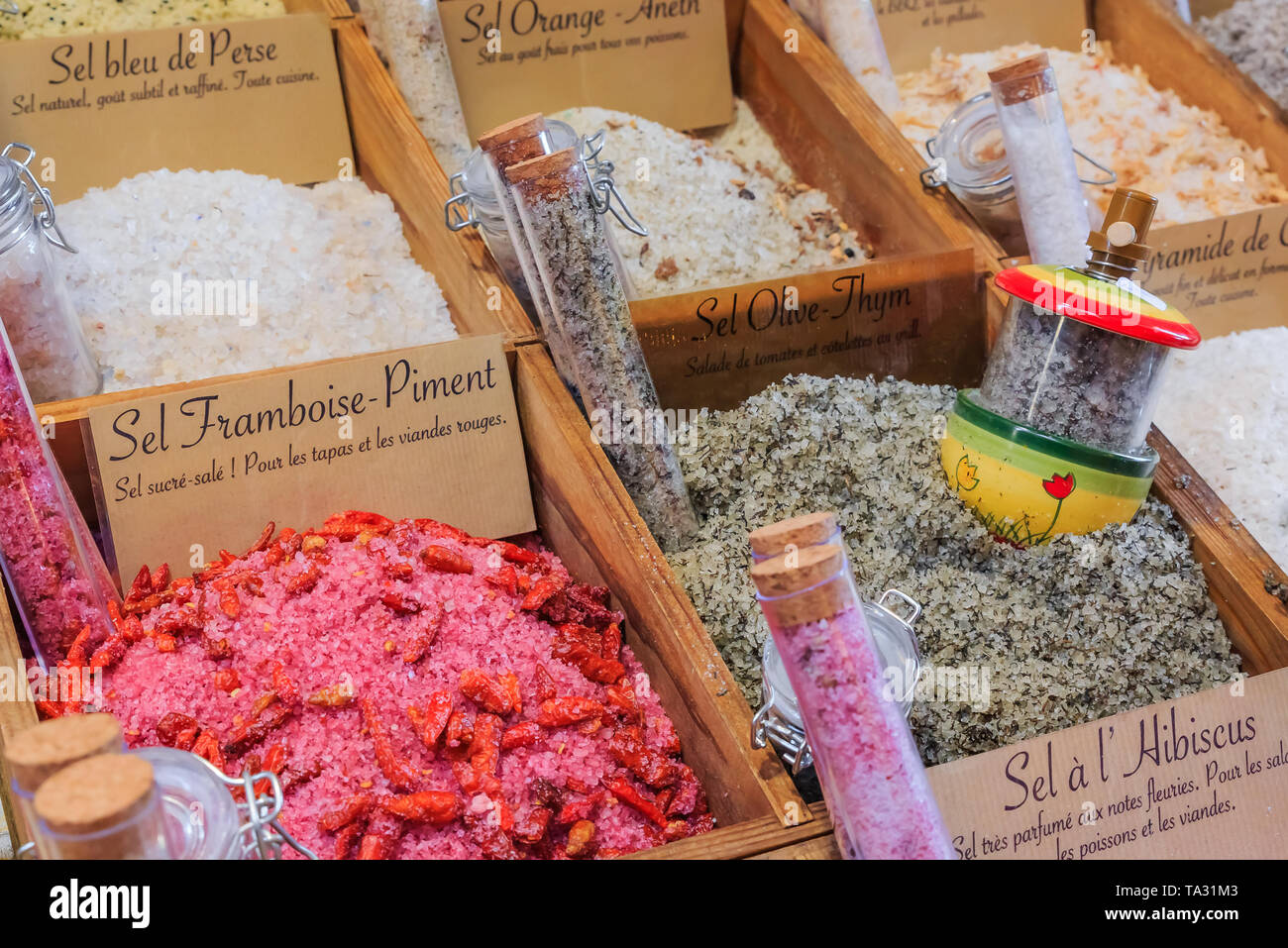 Exotic flavored salts with thyme, orange, strawberry chili and other herbs and spices for sale at a local outdoor farmers market in Nice, France Stock Photo