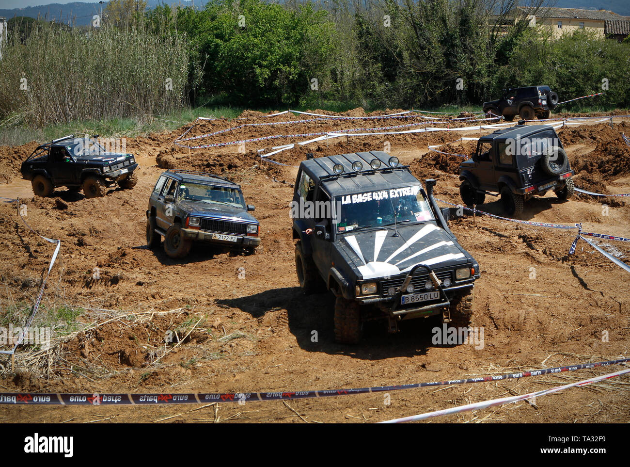 Four wheel drive cars tackling a mud circuit in Spain Stock Photo
