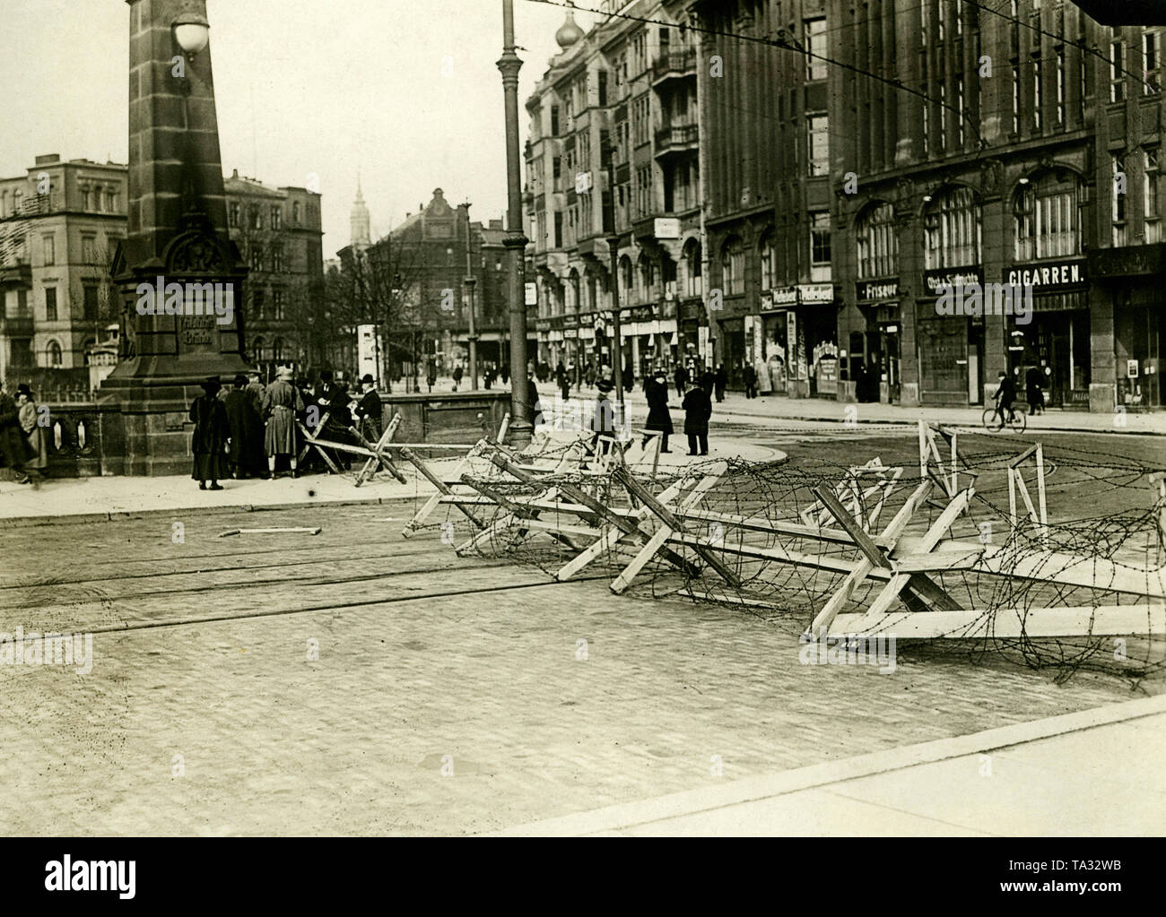 Roadblock on the Friedrichs bridge after the Maerzkaempfen (March fighting) in Berlin, at the crossing of the tramway in the Neue Friedrichstrasse (now Anna-Louisa-Karsch-Strasse, Berlin Mitte). In the background, stores with partially barricaded shop windows. Stock Photo