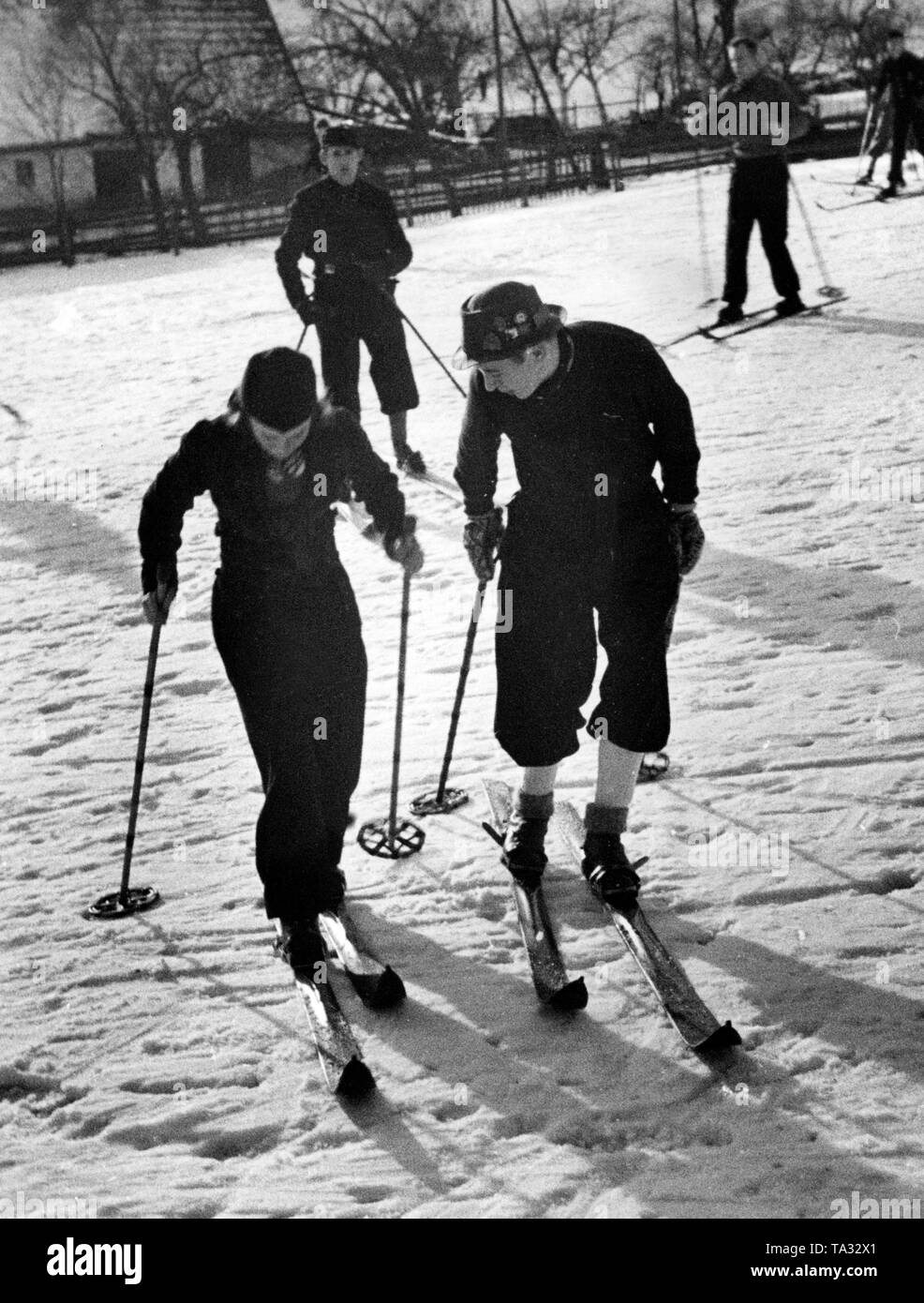 A ski instructor from the sports office teaches a student during a ski course of the Nazi organization 'Kraft durch Freude' ('Strength through Joy') in Agnetendorf (Jagniatkow) in the Krkonose. Stock Photo