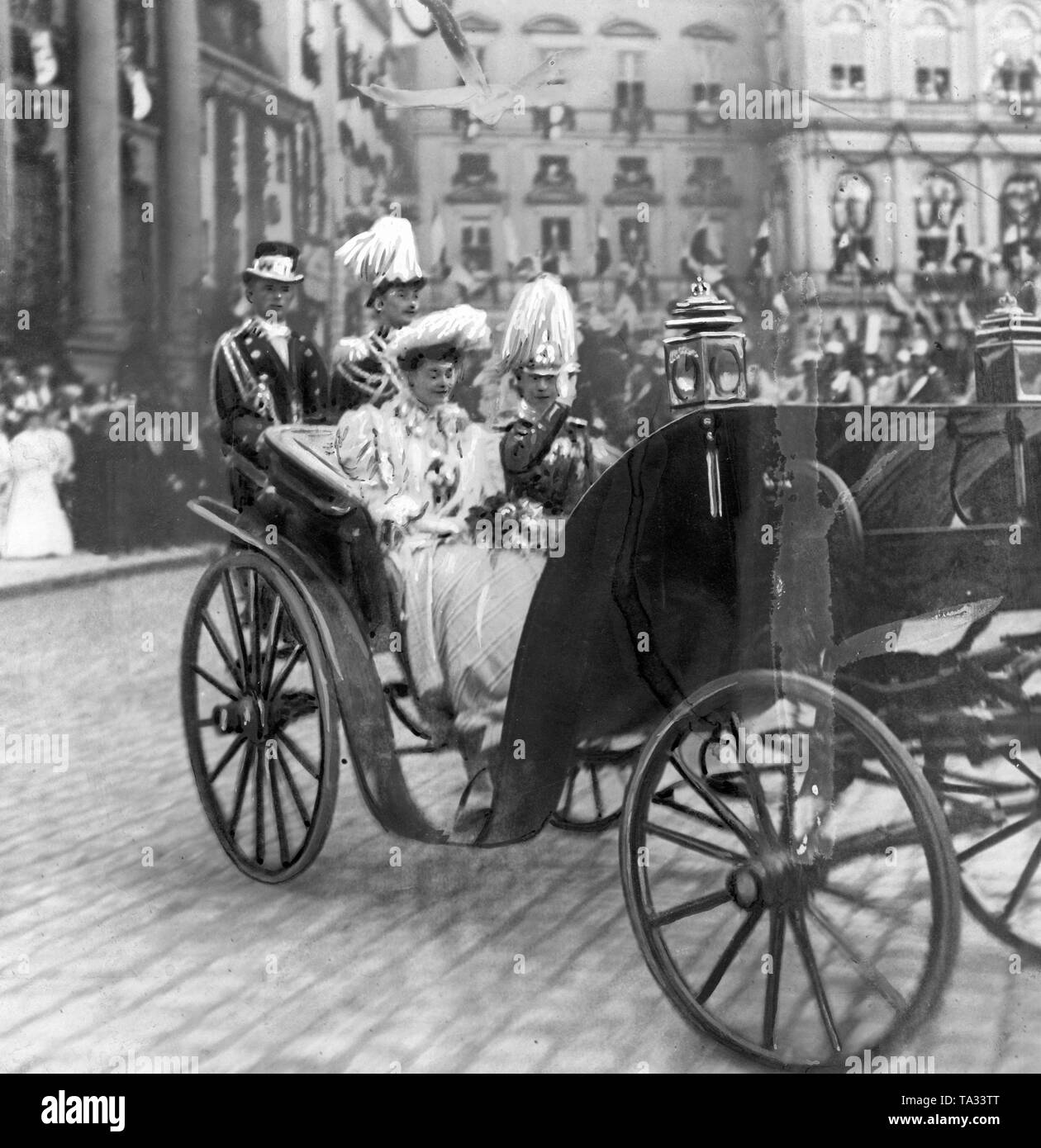 Crown Princess Cecilie von Mecklenburg and Crown Prince Wilhelm of Prussia drive here in a coach at the Potsdam City Palace, as part of the celebrations lasting for several days in Berlin and Potsdam. It is the last part of the ceremonial entry of the Crown Prince and Princess into their summer residence. Stock Photo