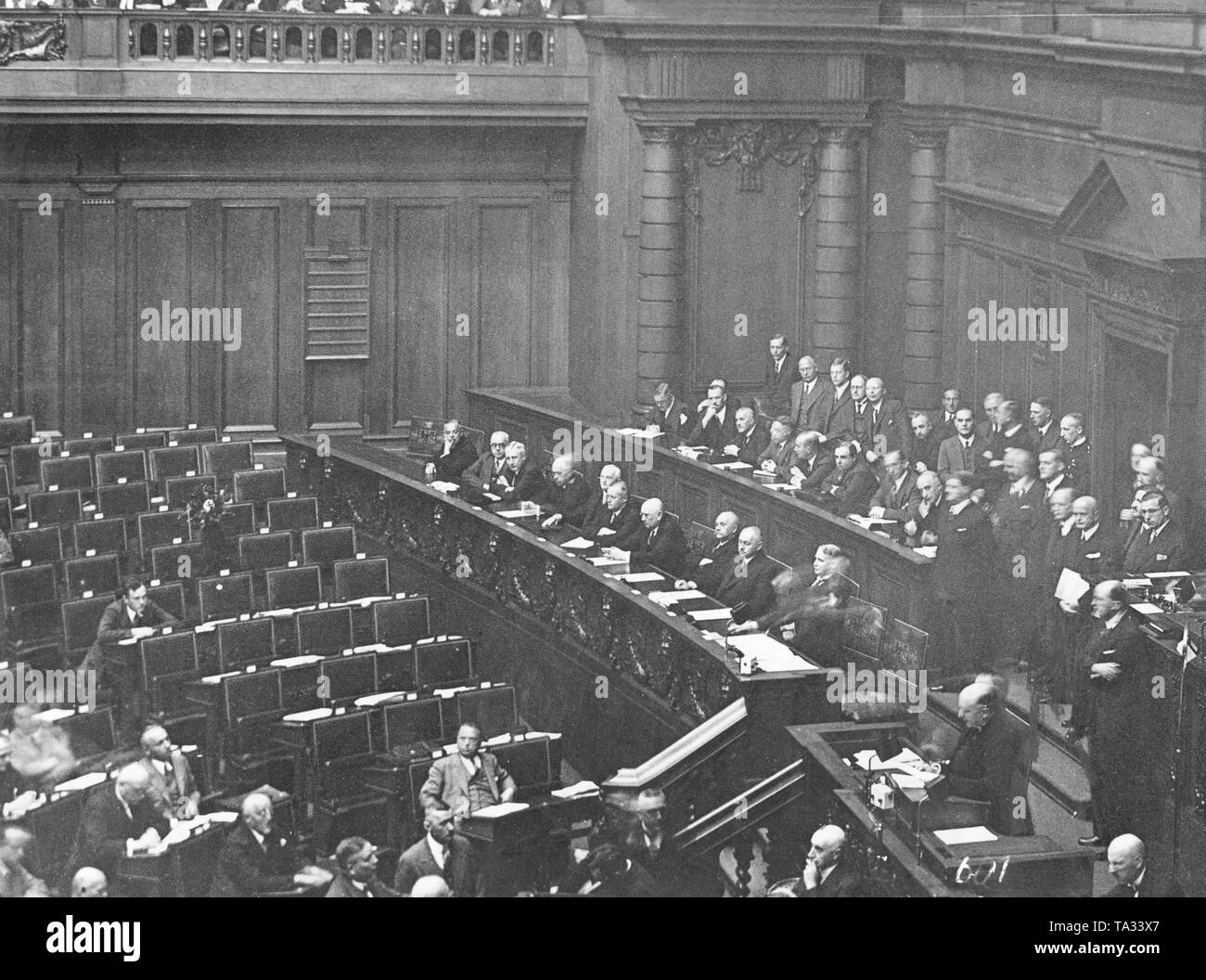 As a protest against the government, the entire NSDAP faction in the Reichstag had left the meeting room. Here, the empty seats of the NSDAP as well as in the lower right of the picture Chancellor Bruenung is holding a speech. Stock Photo