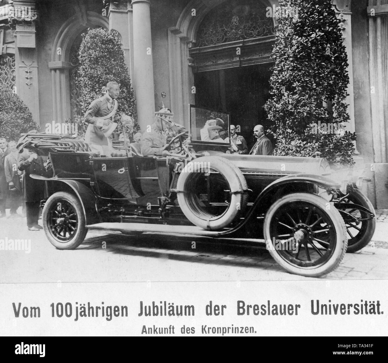 Crown Prince Wilhelm visits the University of Wroclaw on the occasion of its 100th anniversary, Here the Crown Prince (backseat, standing) is driving in front of the entrance to the university. Stock Photo