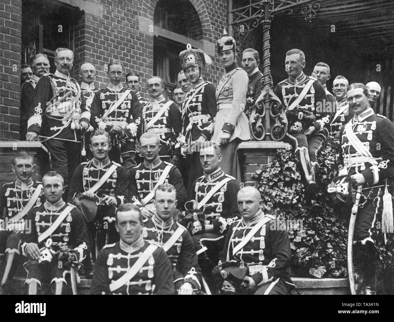 Emperor Wilhelm II (3rd row, 1st from left) visited together with his daughter Viktoria Luise of Prussia (3rd row 4th from left) his eldest son Crown Prince Wilhelm of Prussia (3rd row, 2nd from left) and his wife Crown Princess Cecilie of Mecklenburg (3rd row, 5th from the left) in Danzig. There the Crown Prince was commander of the 1st Leibhusaren Regiment. The members of the Prussian royal family wear the uniforms of their respective Leibhusaren regiment, Crown Princess Cecilie the uniform of the Dragoon Regiment King Frederick III (No. 8). Stock Photo