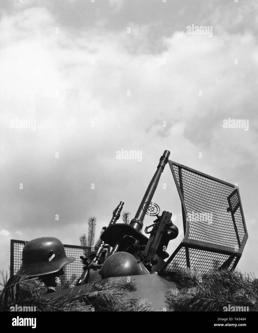 The armament of an SdKfz 222 armored car, consisting of a 2-cm cannon and an Mg-34, is put into position for air raid defense. Stock Photo