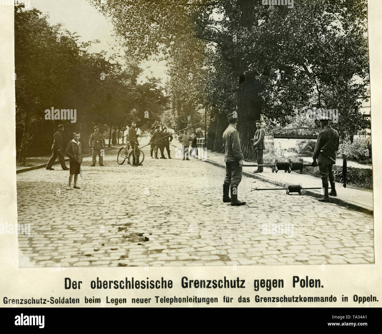 Soldiers of the Upper Silesian Border Guard, a volunteer unit formed of Freikorps members during the Polish uprisings in Upper Silesia, equip their headquarters in Opole with telephone lines. Stock Photo