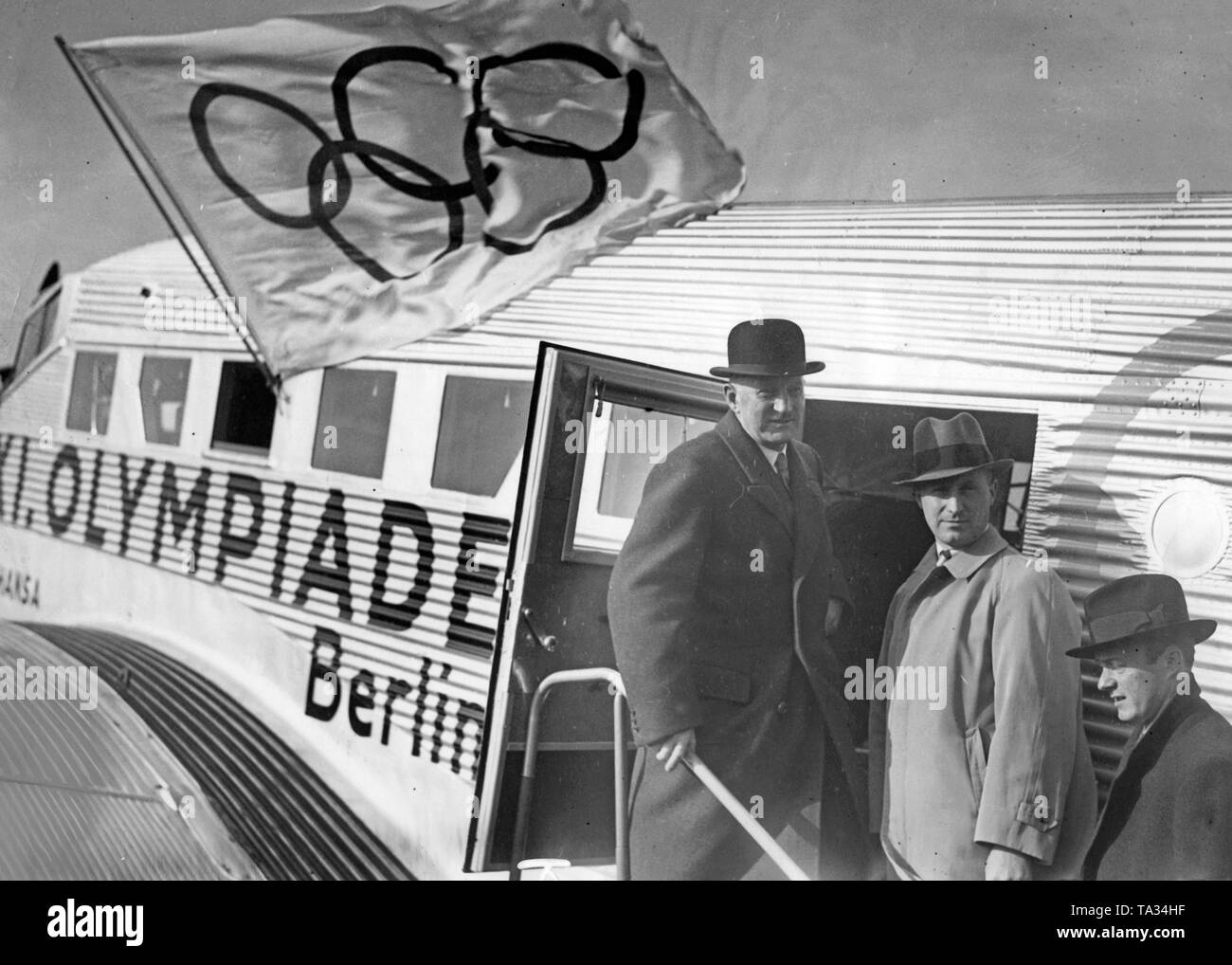 The general secretary of the Olympic Committee Carl Diem goes on a promotional tour for the Olympic Games in Berlin, 1936, aboard a Junkers Ju 52 / 3m of the Lufthansa. The aircraft with the registration D-ALYL had the special ornamental painting of the Olympic rings. Stock Photo