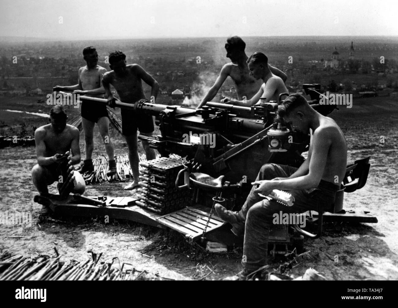 Soldiers clean their 3.7 cm flak (36 or 37) during a pause in the fighting. They are located on a hill near the river Donets. Photo of the Propaganda Company (PK): war correspondent Scheffler. Stock Photo