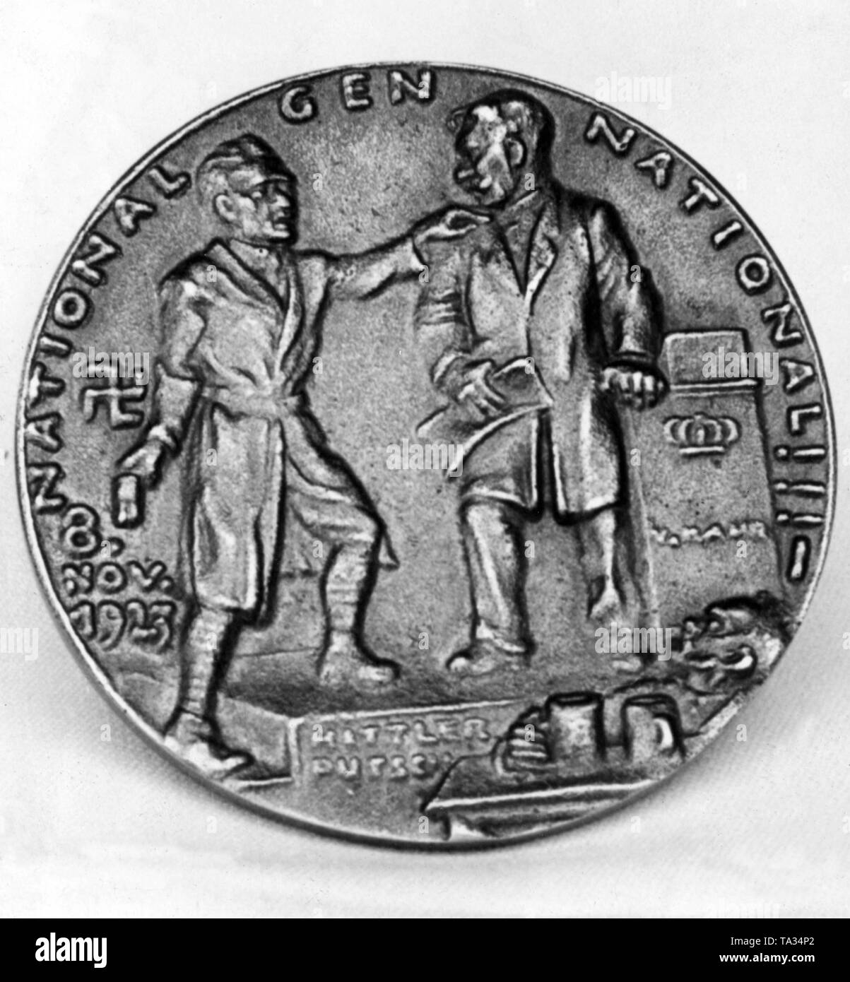 Back of a medal on the Beer Hall Putsch by Karl Goetz. The Beer Hall Putsch is depicted as the 'Munich Theater'. Hitler (l.) is at the lectern and Kahr (r.) in the Buergerbraeukeller. In front is a listener with beer mugs on the table. Under the podium is written 'Hitlerputsch'. The inscription reads: '8 Nov. 1923 National Gen National !!!' Stock Photo