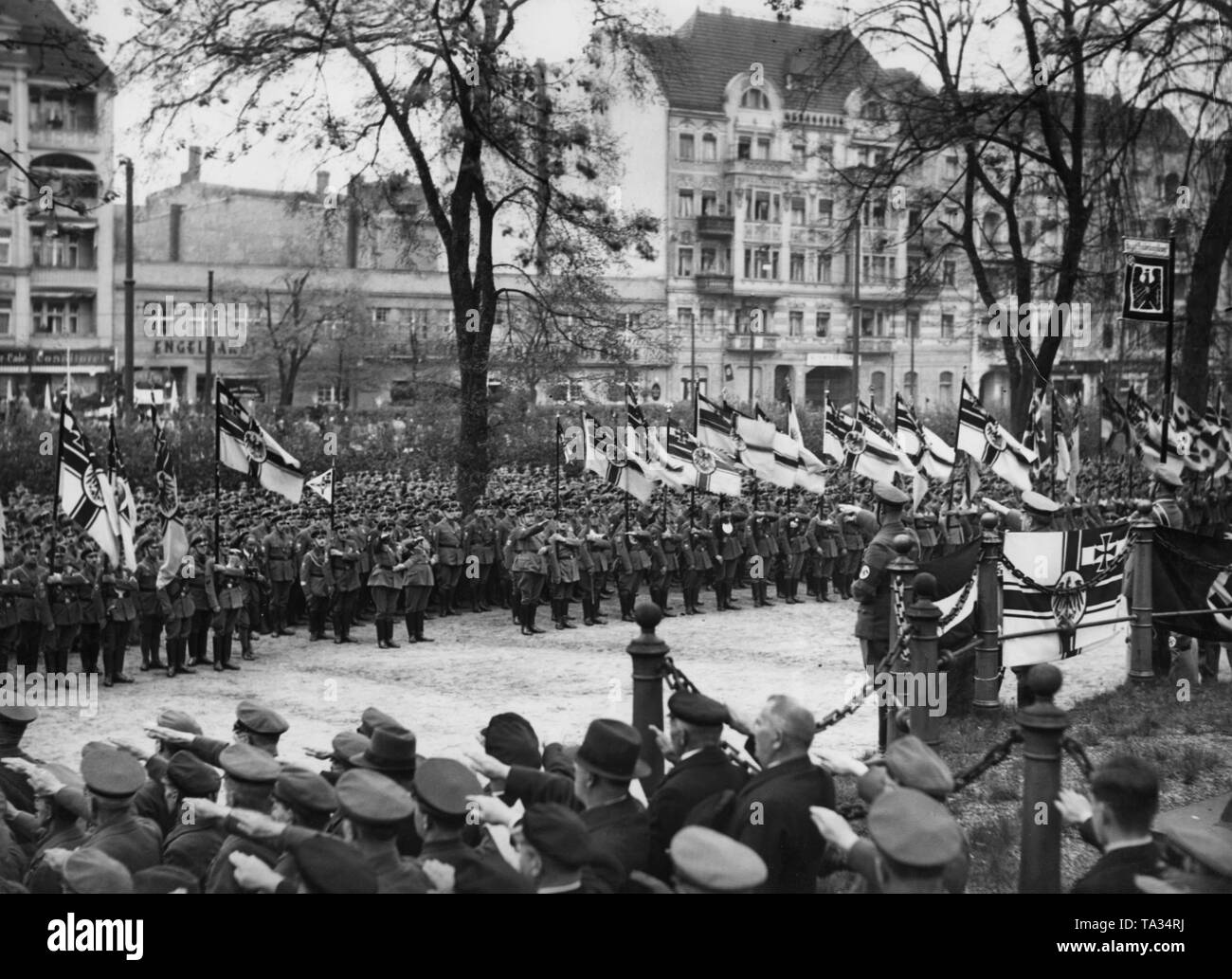 After the reintroduction of compulsory military service, the National Socialist Alliance of Red Front-Fighters (Stahlhelm) decided to remove the black ribbon from their flags. 8,000 men of the Berlin Gau of the Stahlhelm were deployed on Jahnsportplatz in the Volkspark Hasenheide in Berlin, in order to solemnly remove the black ribbons from the flags. Here, during the singing of the national anthem. Stock Photo