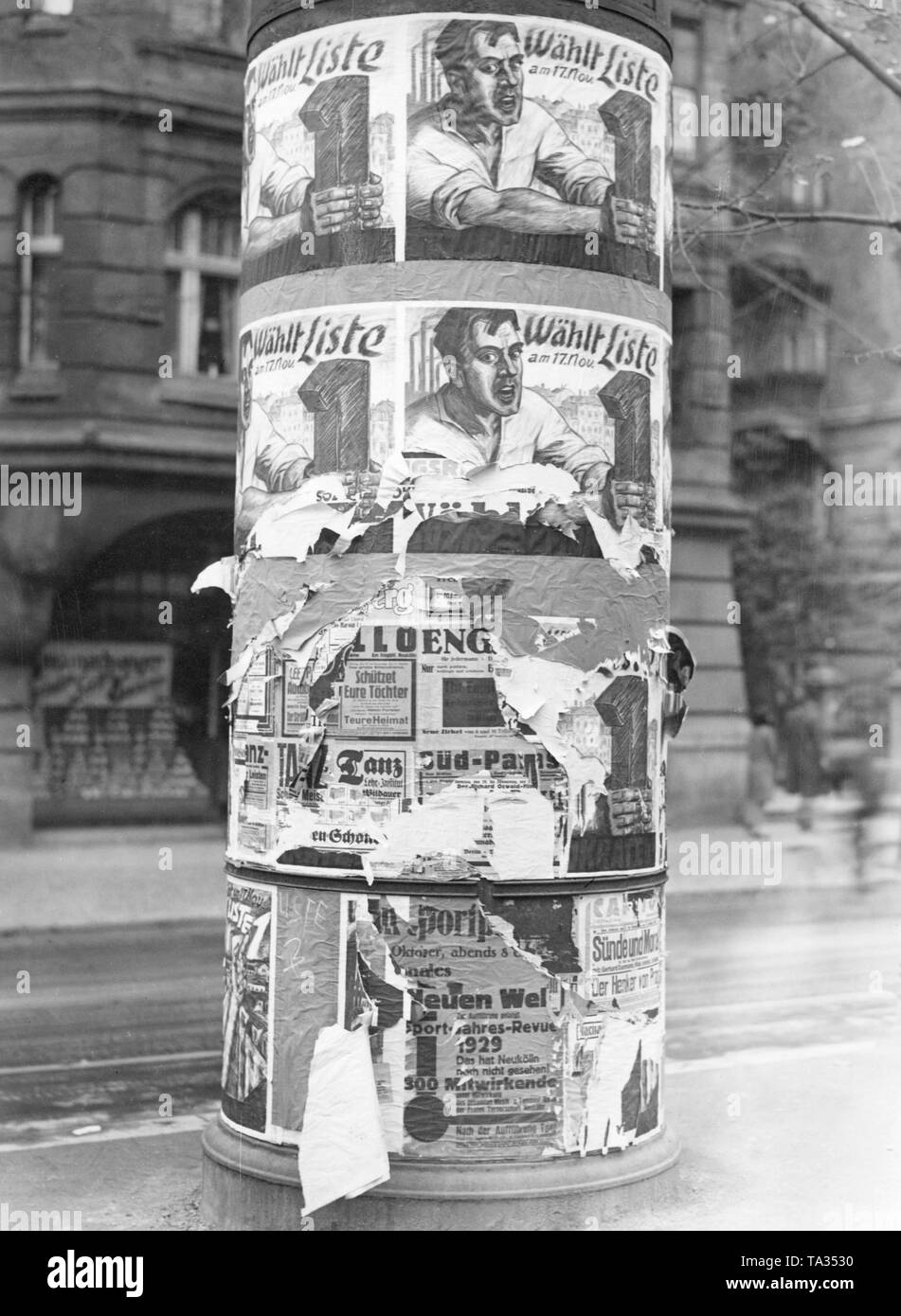 Posters of the SPD for the Prussian state election in 1929 on an advertising column, were torn down by supporters of the KPD. Stock Photo