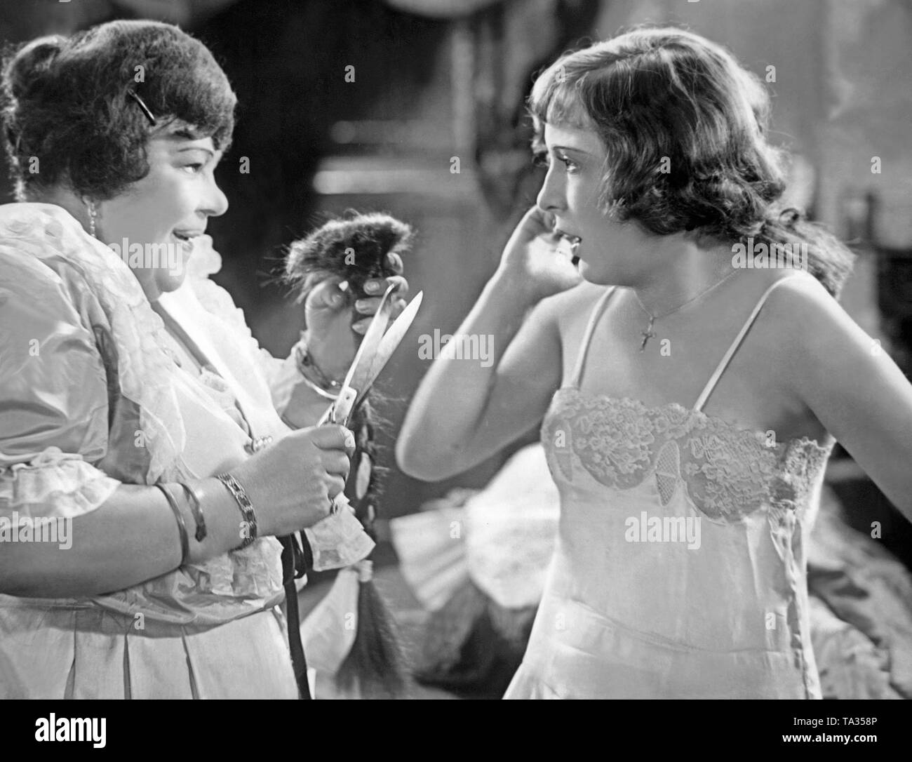 Dita Parlo (r.) and Lydia Tridenskaja (l.) In the movie 'Melody of the Heart'. Parlo in the character of Julia Balog gets a new haircut, a bob. Stock Photo