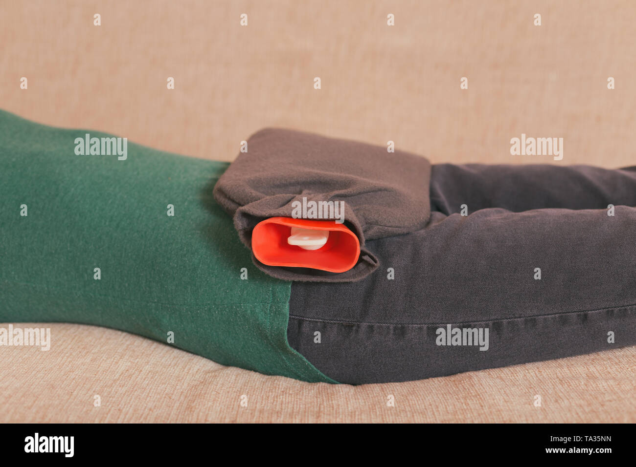 Woman using hot water bottle for stomach cramps.Toned photo Stock Photo Alamy