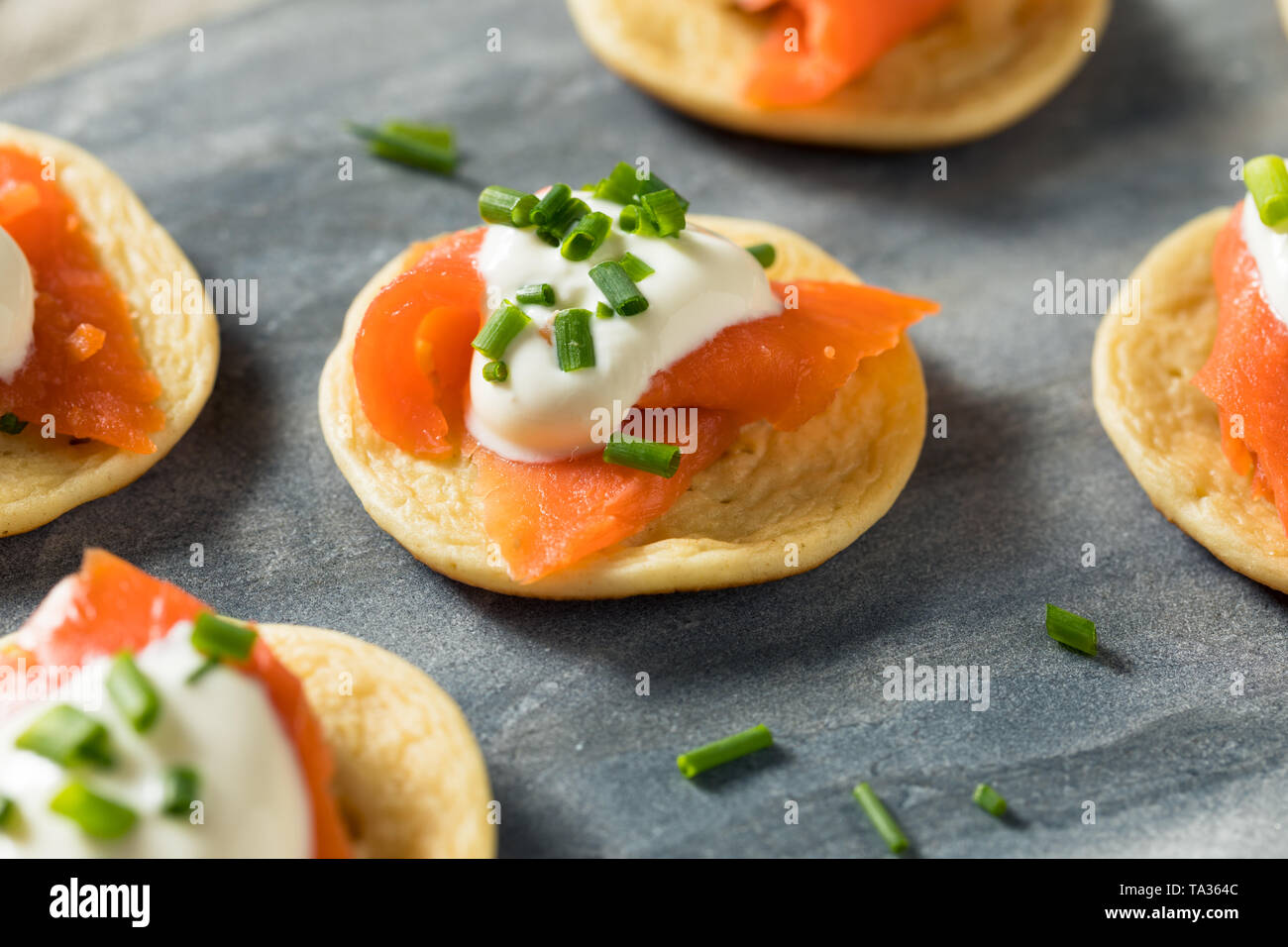Homemade Smoked Salmon Cocktail Blinis with Creme and Chives Stock Photo