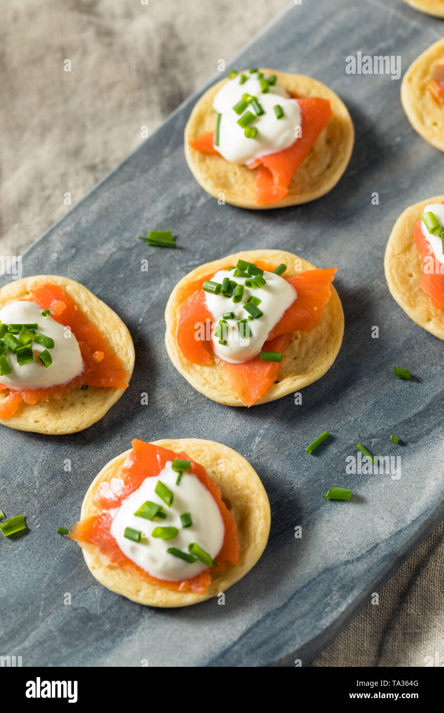 Homemade Smoked Salmon Cocktail Blinis with Creme and Chives Stock