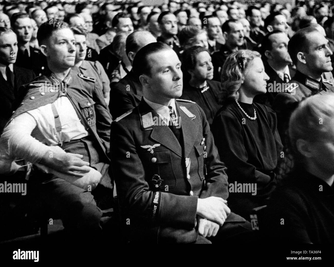 View of the audience at the celebration the evening before Adolf Hitler's birthday in the Berliner Philharmonie. Wounded guests attended the event as guests of honor. Here, soldiers of the Army and of the Luftwaffe (officer of the fighter wing Moelders), as well as workers of the armament industry. Photo: Hoffmann Stock Photo