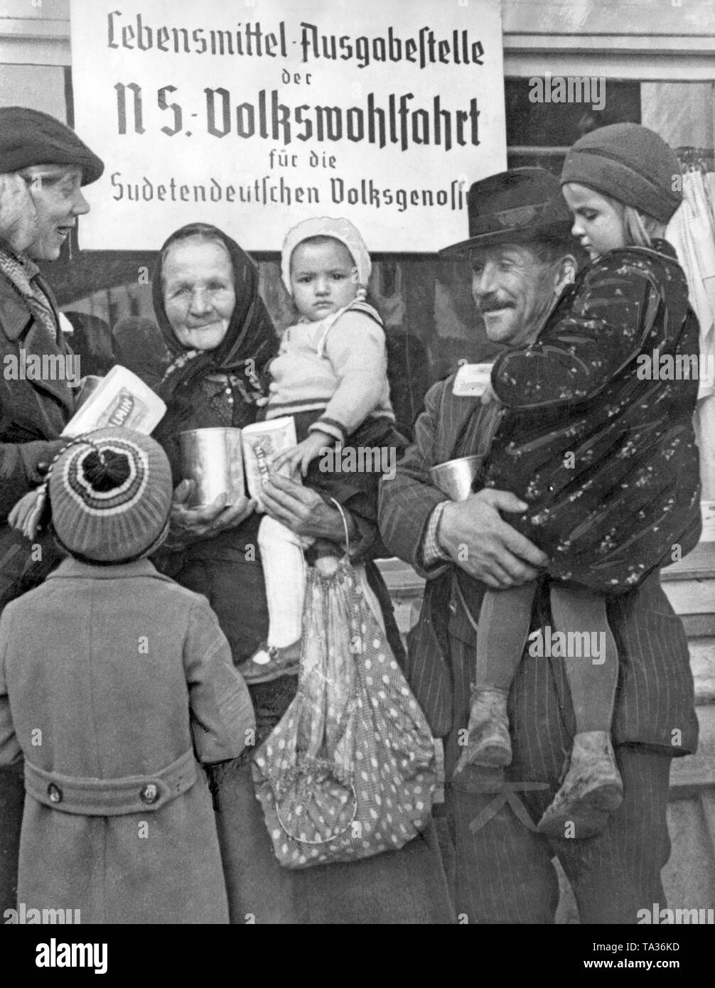 People in front of a food issuing office of the National Socialist People's Welfare in Prachatitz (today Prachatice) on October 11, 1938. Stock Photo