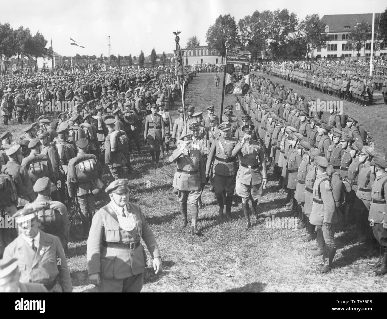 At a roll call of the Stahlhelm Crown Prince Wilhelm of Prussia (saluting, at right), along with the Federal Chairman Theodore Duesterberg (on the left) inspects the ranks of the lined up members. Stock Photo