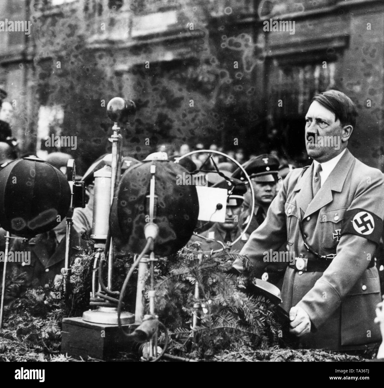 Hitler during his speech to the German youth in the Lustgarten, Berlin. In front of the lectern, various microphones, including a Neumann bottle and a Reisz microphone. Stock Photo