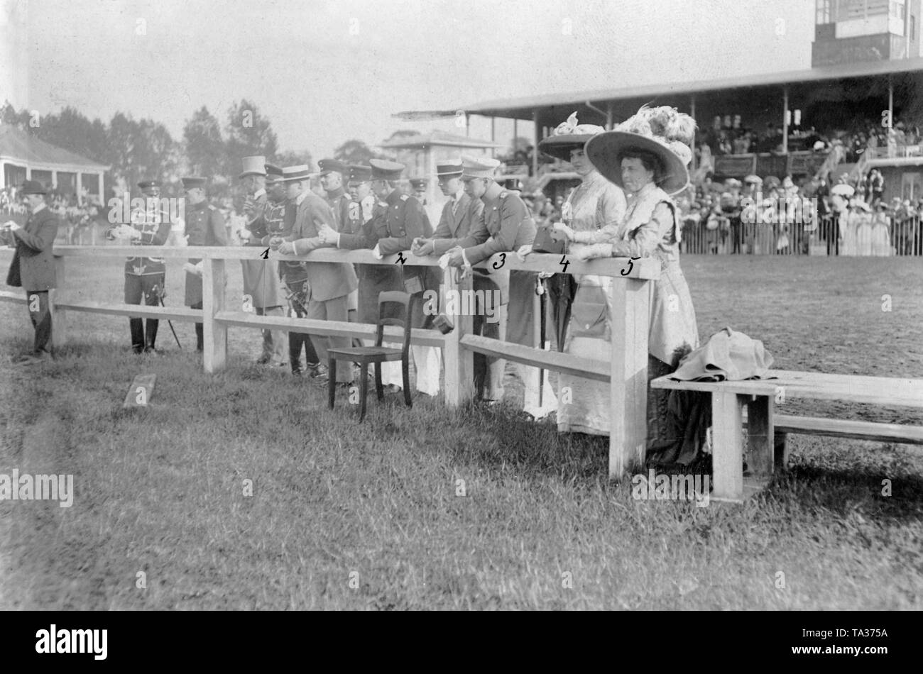 The imperial family watches the Concours hippique at the racecourse. From 1 to 5: Prince Eitel Friedrich of Prussia (1), Prince Joachim of Prussia (2), Crown Prince Wilhelm of Prussia (3), his wife Crown Princess Cecilie of Prussia, born Duchess of Mecklenburg (4), Princess Sophie Charlotte, born Duchess of Oldenburg and wife of Prince Eitel Friedrich (5). Stock Photo