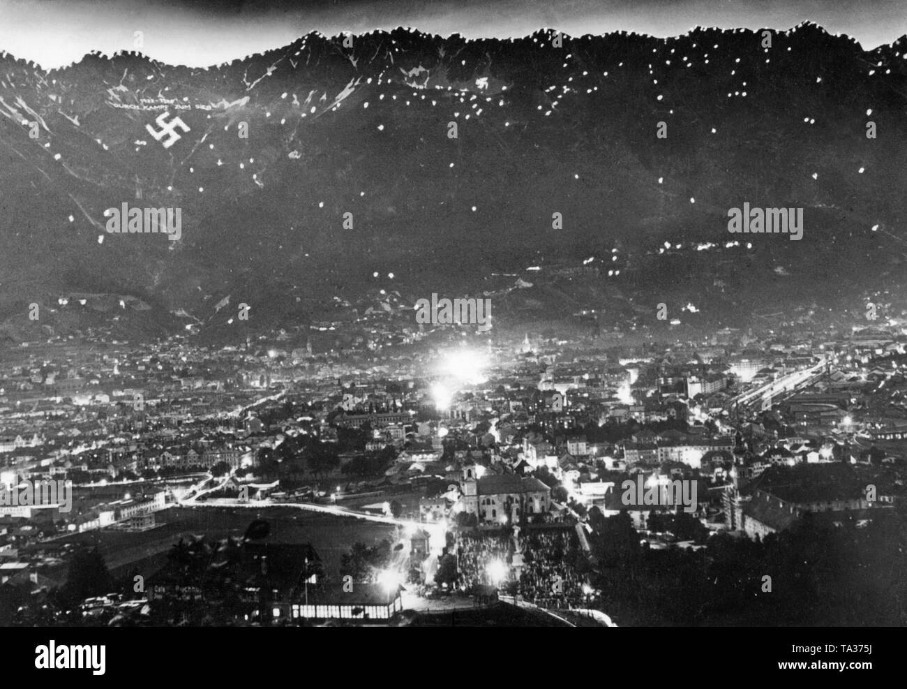 Solstice celebration in Innsbruck. On the mountain is a swastika and the lettering: '1933-1938. With battle to victory'. Stock Photo