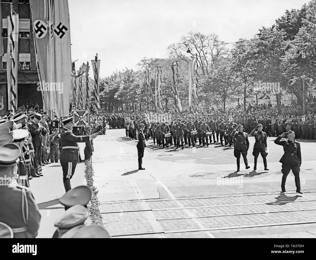 Photo of the general staff of the Luftwaffe (at the very front, the saluting commander Major General Wolfram Freiherr von Richthofen) marching in front of the chief commander of the Luftwaffe (German Air Force) Hermann Goering (on the left with the general's baton) at Karl Muck Platz (today, Johannes Brahms Platz ) in Neustadt (Hamburg) on May 30, 1939. Behind, a marching band of the Legion. Stock Photo