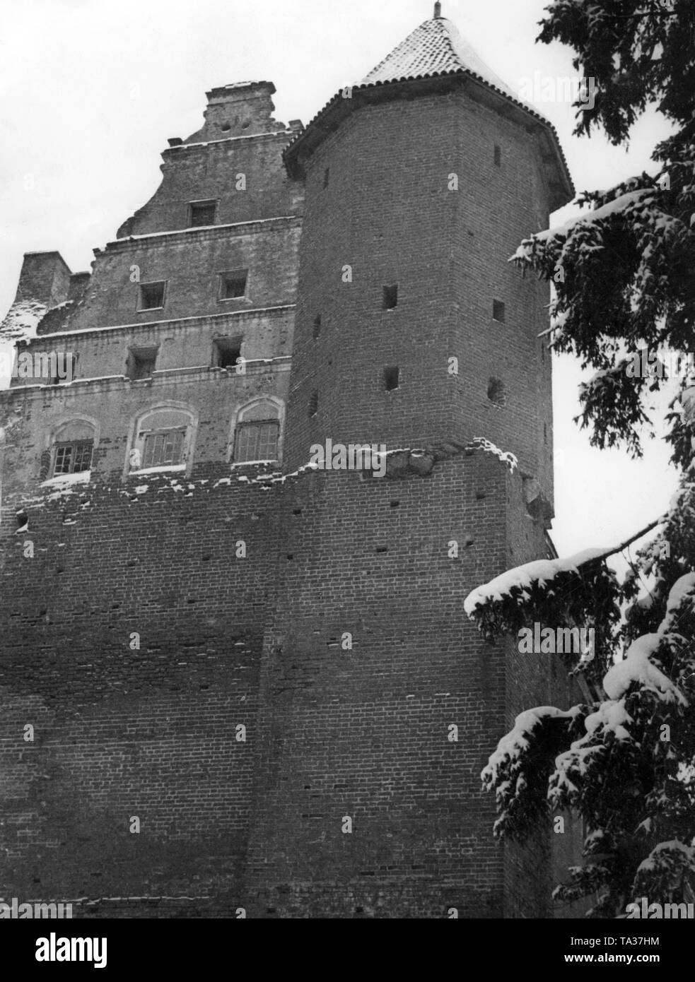 Pictured is the northwest tower of the castle complex Schoenberg at Ilawa in East Prussia / Germany with the front of the kitchen wing. Stock Photo