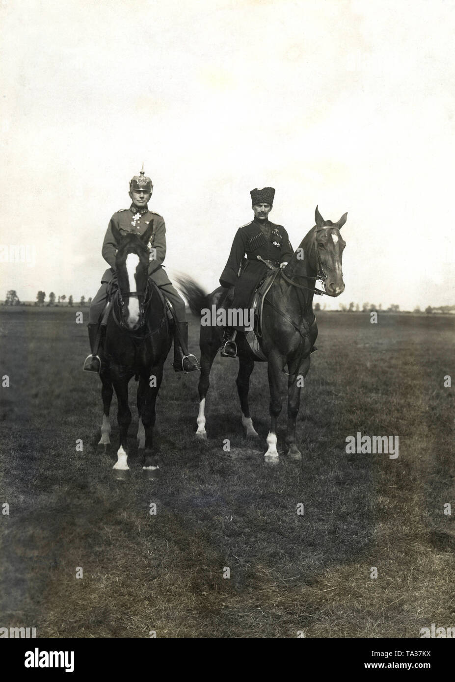 The supreme commander of all German troops in the Baltic States, General Rudiger von der Goltz (left, with spiked helmet), and Prince Pavel Rafalovich Bermont-Avalov (right, in Cossack uniform), commander of the so-called West Russian Liberation Army, on their horses at a military review of the Iron Division in Mitau (Latvian: Jelgava). Stock Photo