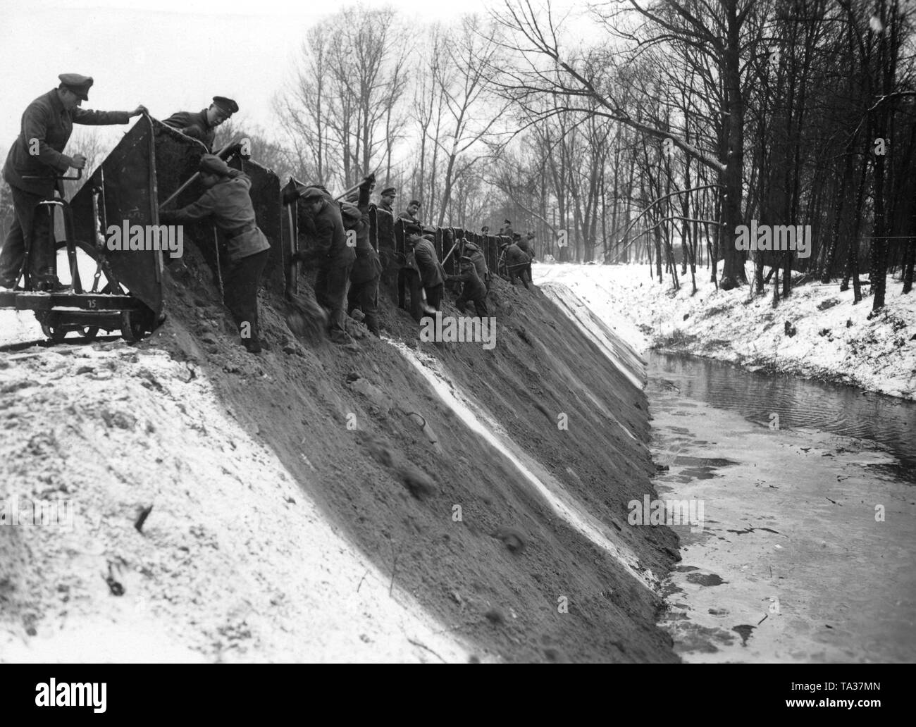 Men of the Voluntary Work Service of the Stahlhelm are filling up a brook or a swamp with soil presumably for the Reichsforschungsiedlung Haselhorst near Berlin-Spandau. Stock Photo