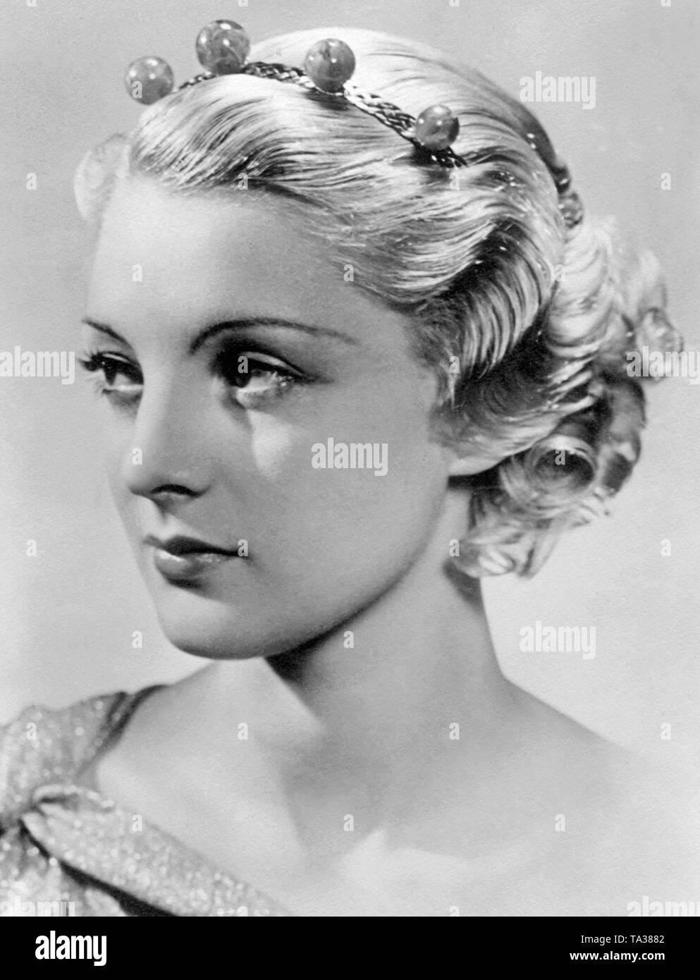 Woman with contemporary hair fashion in the 1930s. The thin eyebrows are also typical for that period. Stock Photo