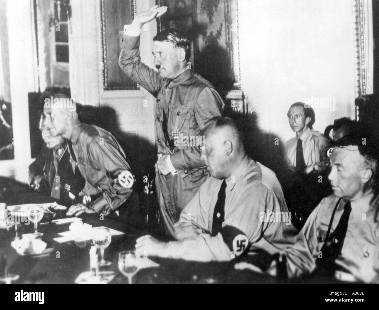 After the Reichstag election, the 230 deputies of the NSDAP were sworn in by the party leaders in Hotel Kaiserhof in Berlin. From left to right: Hermann Goering, Wilhelm Frick, Adolf Hitler, Gregor Strasser, and Joseph Goebbels in the background. Stock Photo