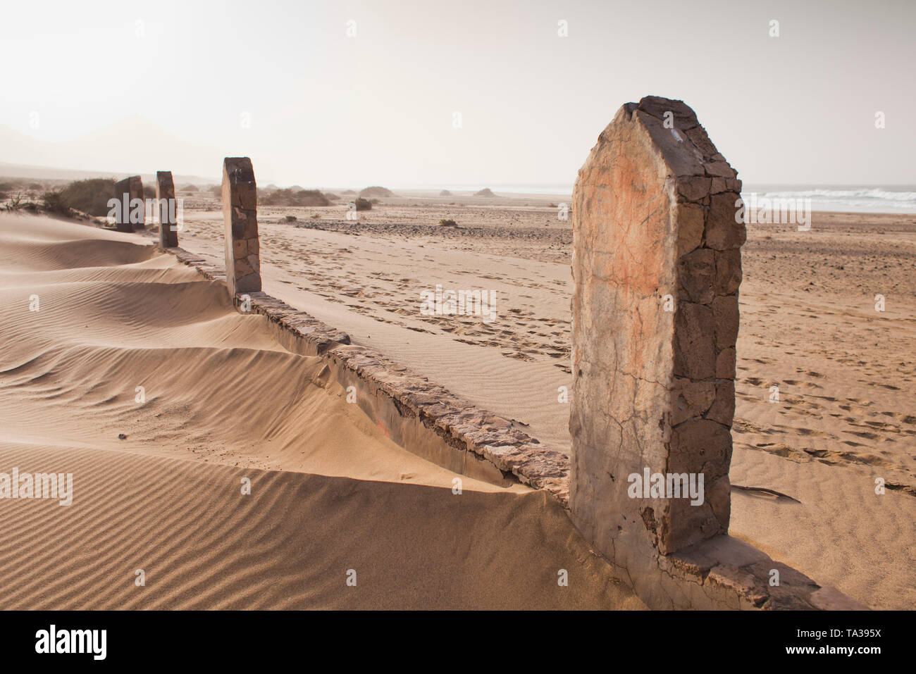 Сhristian Graveyard with abondend cemetery gate on sand dunes at Cofete beach during sunset, Fuerteventura, Canary Islands, Spain, February 2019 Stock Photo