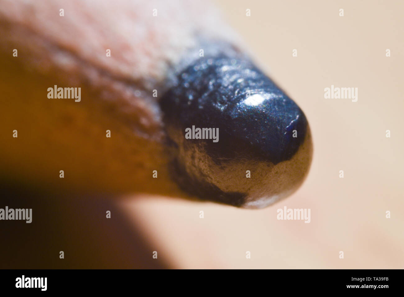 Macro detail shot of a pencil graphite tip with warm background Stock Photo