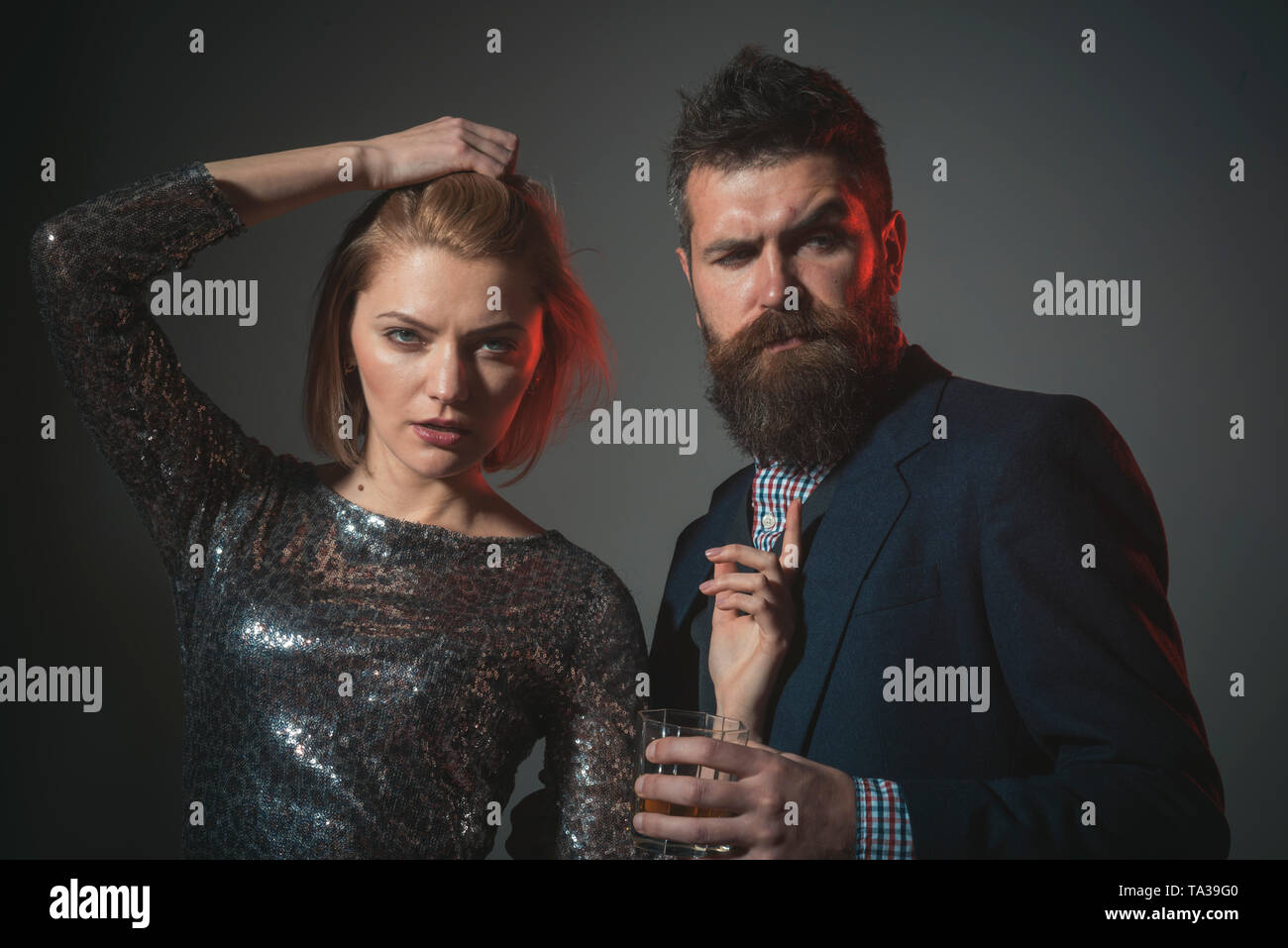 Corporate party concept. Man and woman in fancy clothes drink Stock