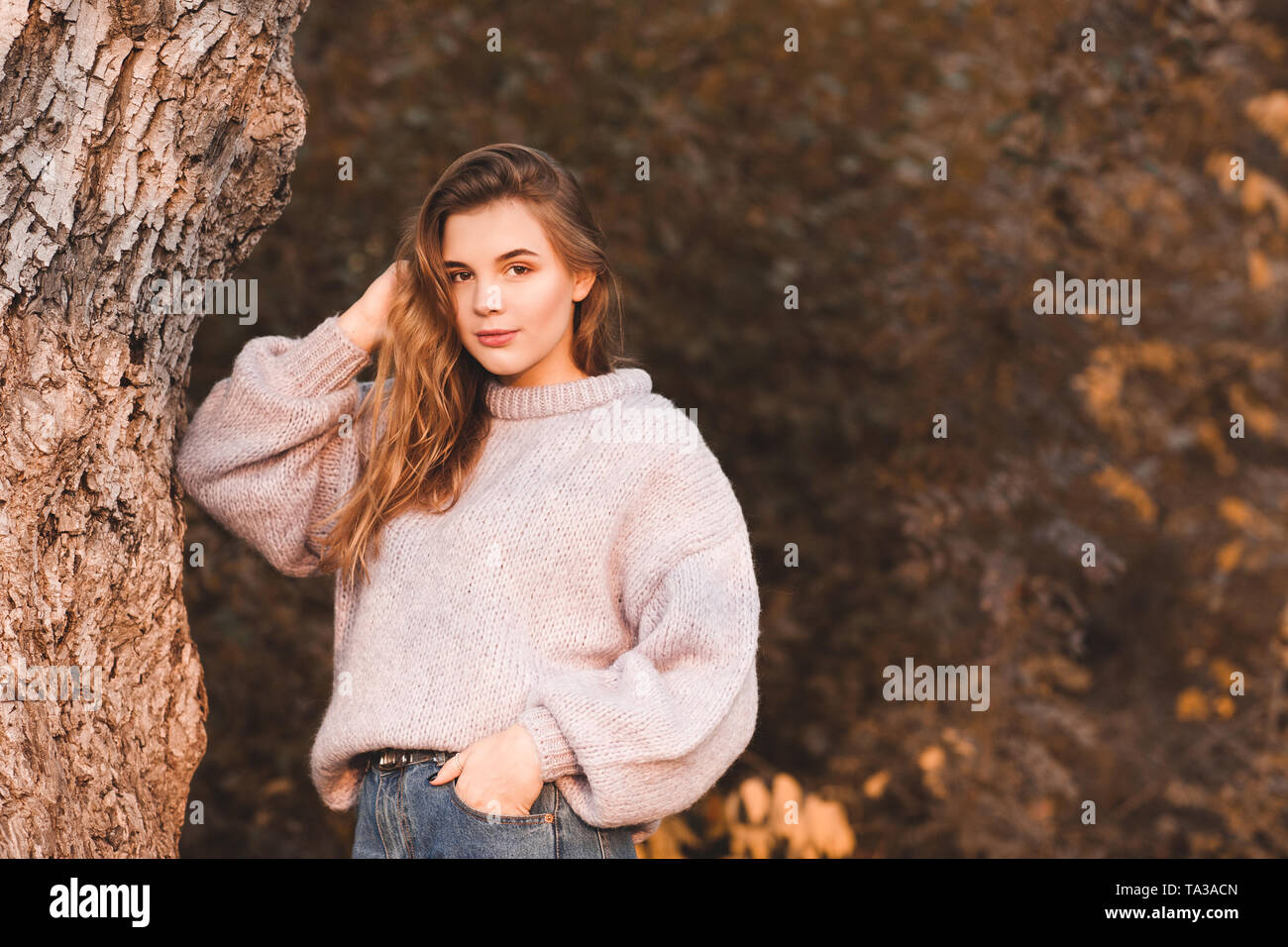Smiling teenage girl 17,18 year old wearing knitted sweater