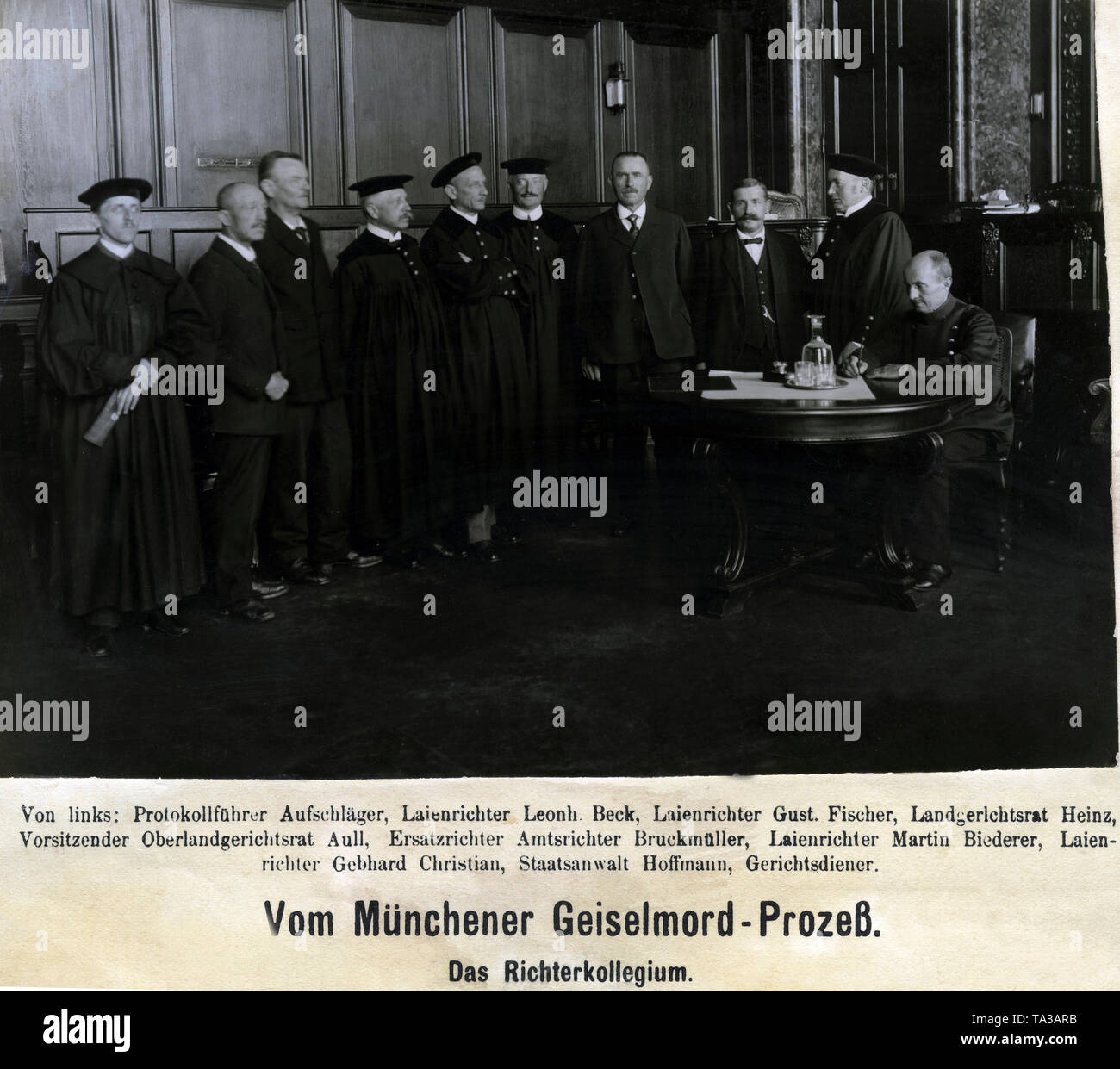 On April 30, 1919 ten members of the government forces were killed in the Luitpold Gymnasium by supporters of the Bavarian Soviet Republic. In September the killers were brought to the people's court of Munich and sentenced to prison terms or death. The picture shows the judges' committee of the trial (from left): clerk, lay judge Leonhard Beck, lay judge Gustav Fischer, District Court Councillor Heinz, chairman of the Higher Regional Court Aull, Circuit Judge Bruckmueller, lay judge Martin Biederer, lay judge Gebhard Christian, prosecutor Hoffmann, court usher. Stock Photo