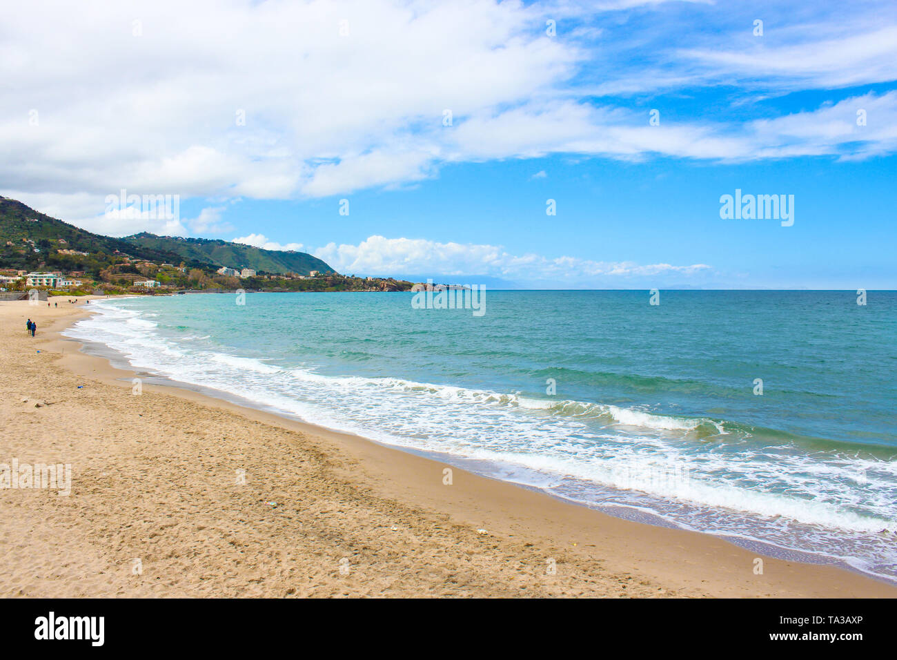 Beautiful sandy beach on the coast of Tyrrhenian sea in Italian Cefalu taken during off season. The small city in Sicily is a popular vacation destination. Stock Photo