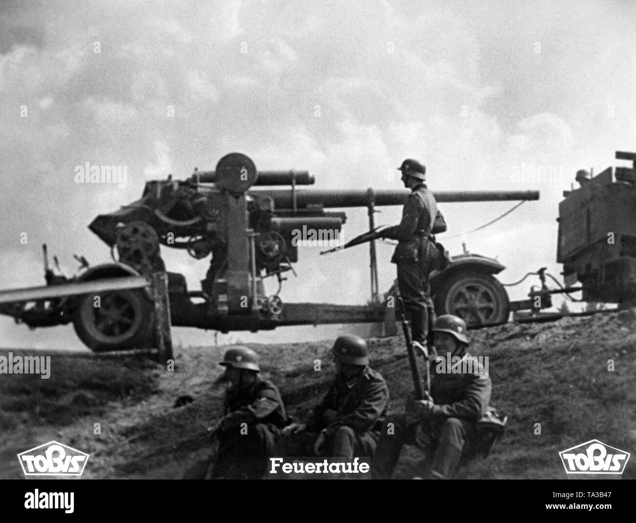 A German 8.8 cm FlaK 18/36/37 in France, before it infantry of the Wehrmacht. Moviestill from the propaganda film 'Feuertaufe' (Baptism of Fire). Stock Photo
