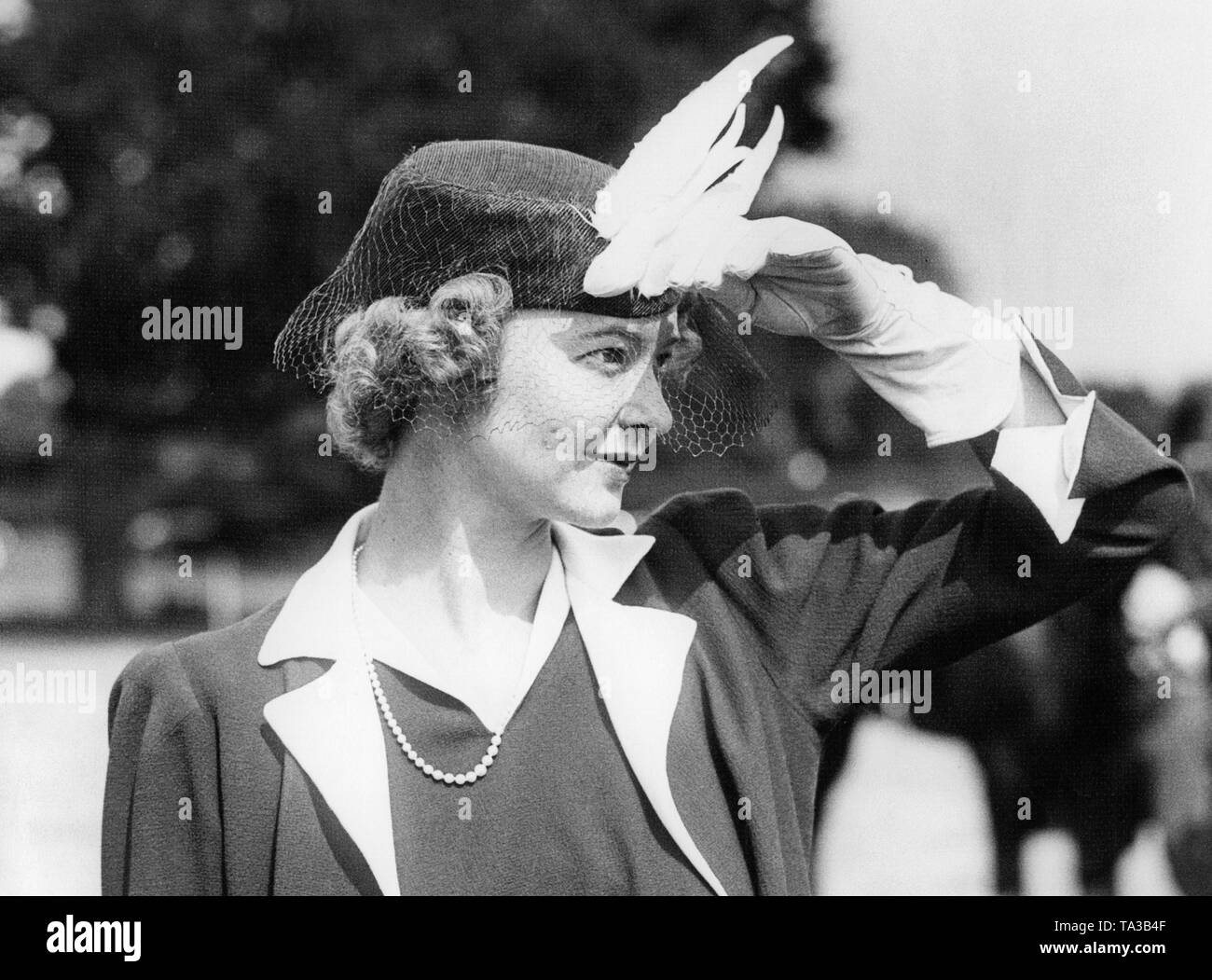 Miss Allison Lawson wears a feathered hat that reminds of a bird of paradise during a polo match at the Ranelagh Club. Stock Photo