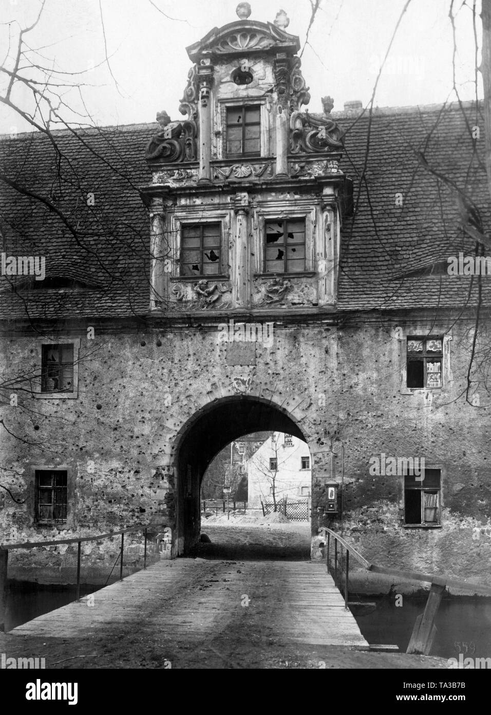 Gatehouse of Castle Doelitz, Saxony, from the 17th century. The castle was fought on 18.10.1813 during the Battle of the Nations near Leipzig - around the gate are the gunshots from the battle. Stock Photo