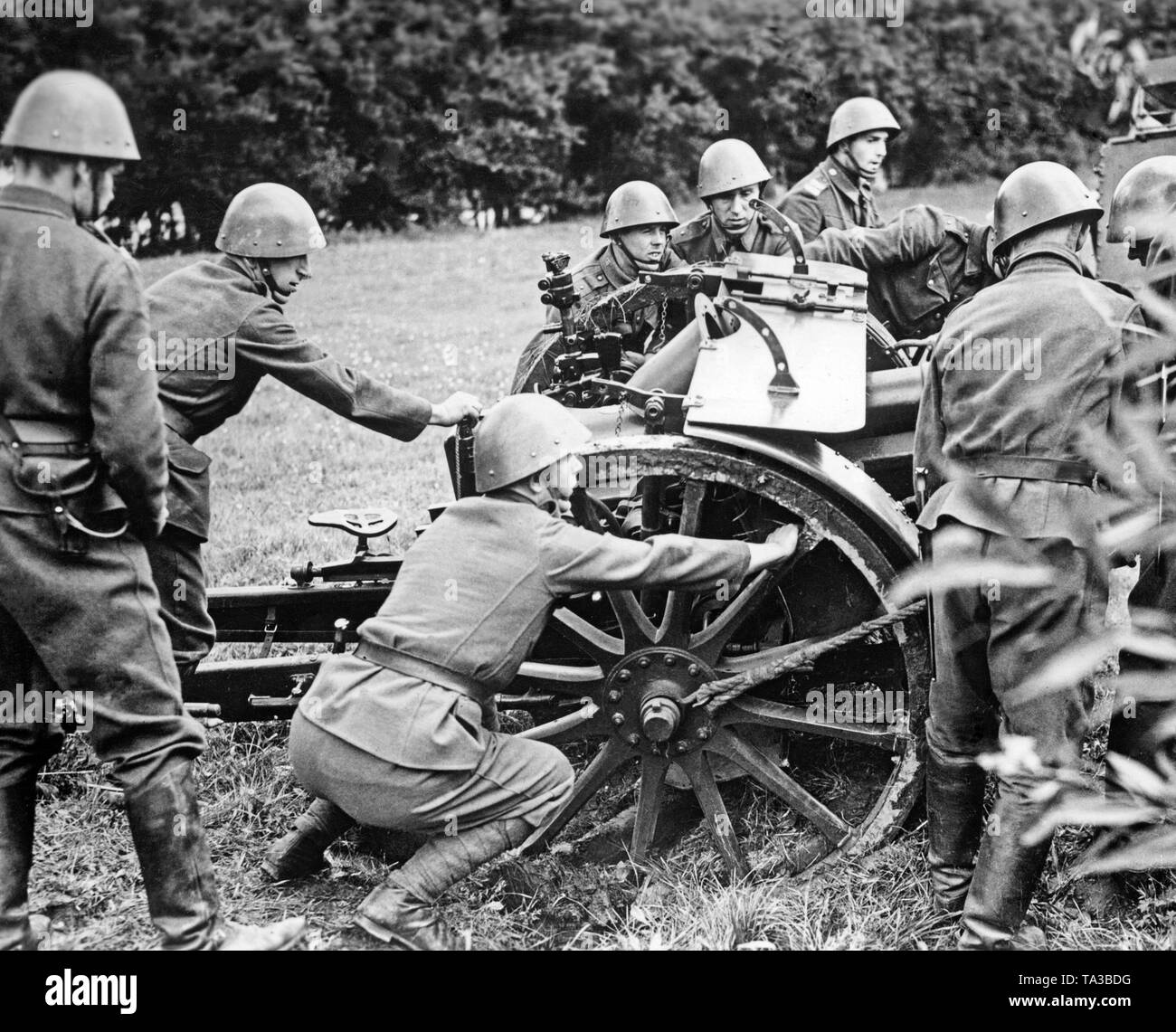 Czech soldiers are positioning a cannon in the suburb of Motol in Prague. After the termination of negotiations between British Prime Minister Chamberlain and Adolf Hitler, the Czech army was mobilized. Stock Photo