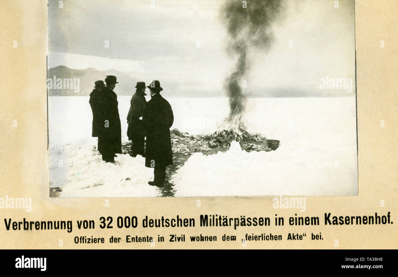 In a barrack yard in Berlin, members of the Allied  Control Commission supervise the burning of 32,000 military passports, in this way also controlling the dismantling of the military bureaucracy. Stock Photo