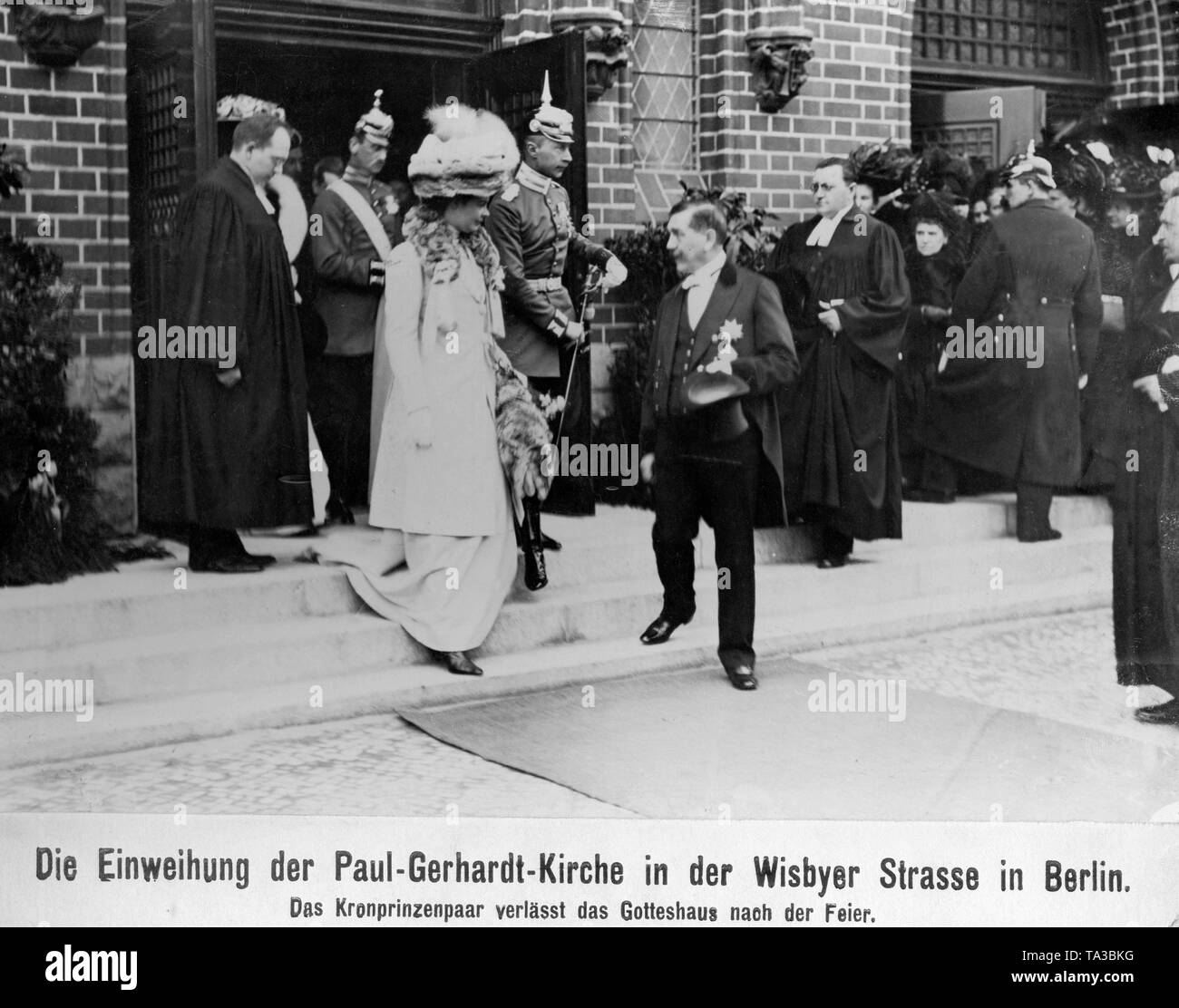 The crown prince couple, Crown Princess Cecilie of Mecklenburg (2nd from left) and Crown Prince Wilhelm (3rd from the left) leaving the church on Wisbyer Strasse after the festive service. Stock Photo